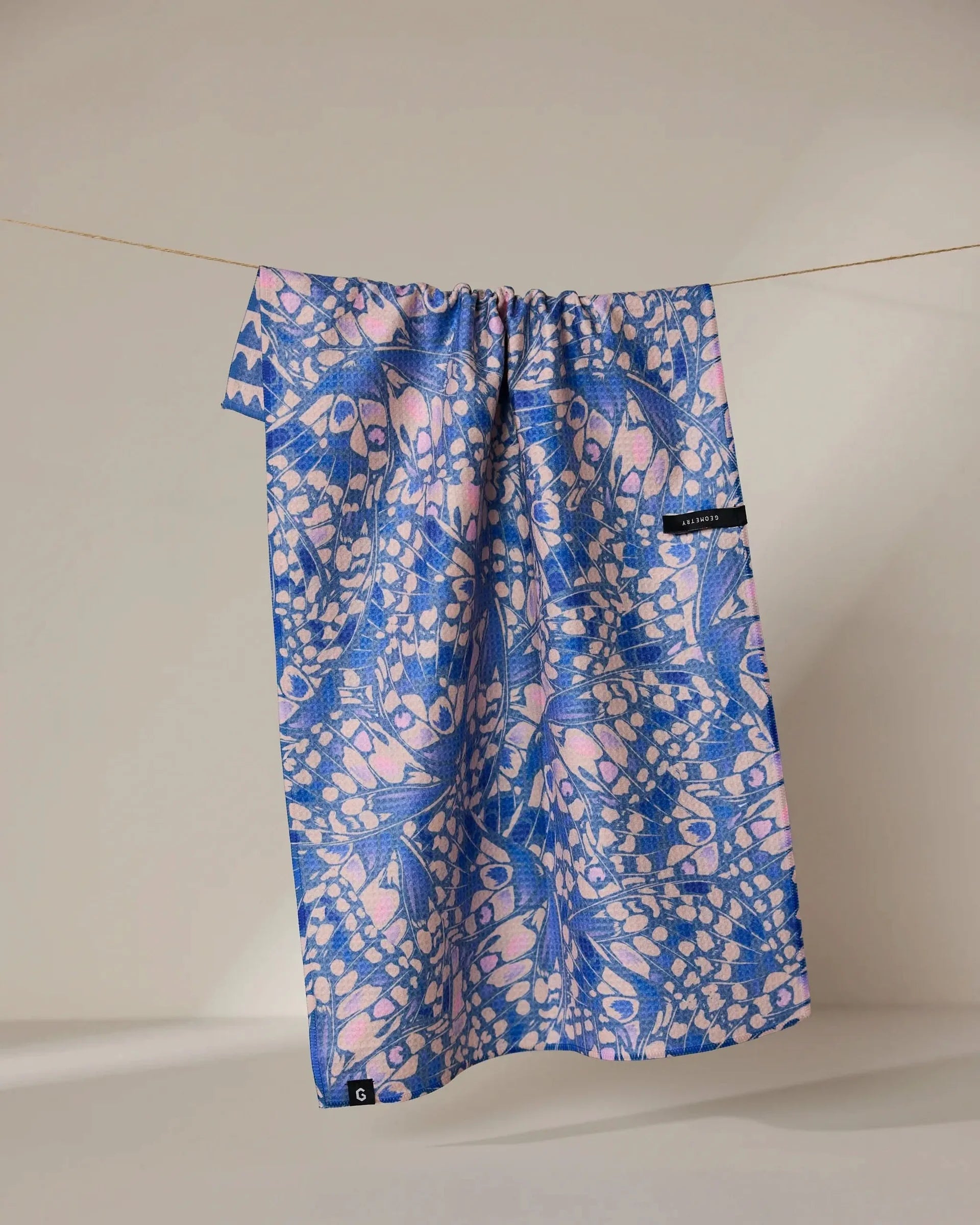 Blue and pink patterned drawstring bag on a white background