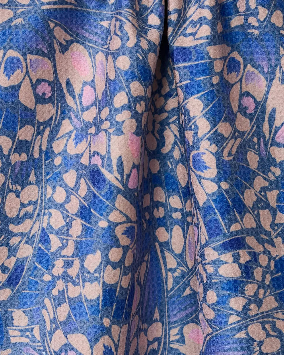 Close-up of a fabric with a blue and beige floral pattern