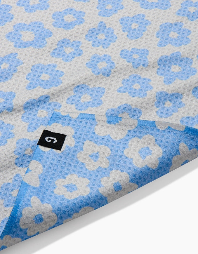 Blue and gray floral patterned paper with a brand logo in the corner.