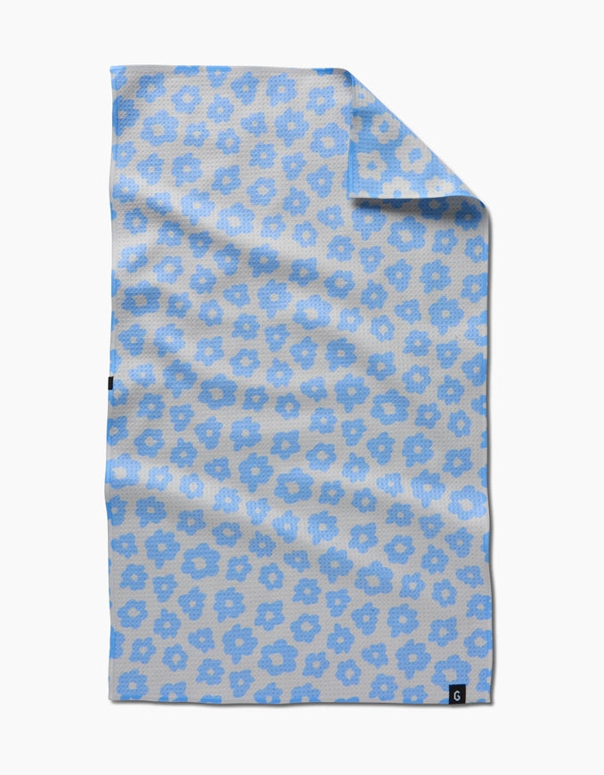 Floral patterned towel with blue flowers on a beige background