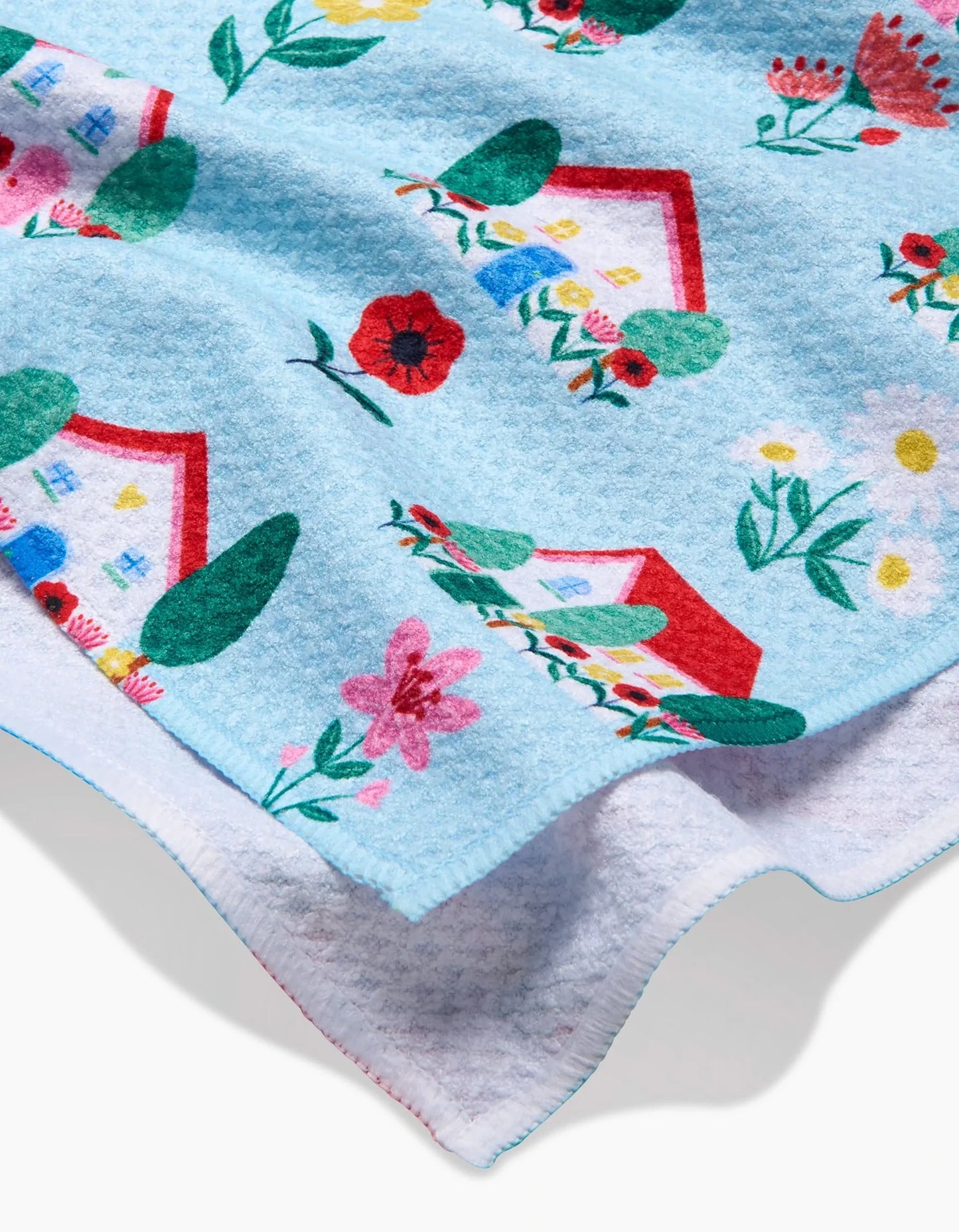 Floral and house patterned fabric on a white background