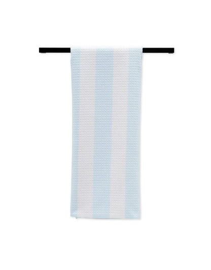 Striped towel hanging on a black rod against a white background