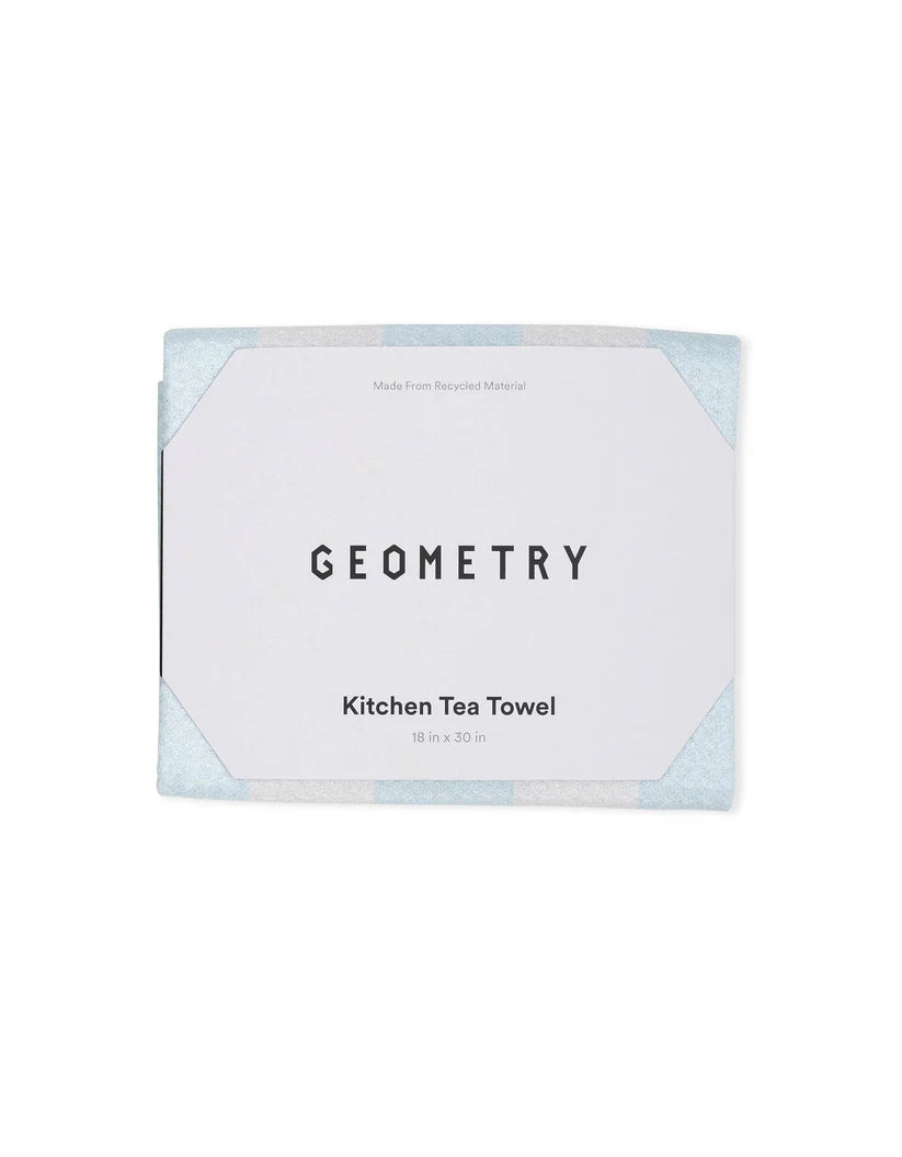 Packaged kitchen tea towel with 'Geometry' branding on a white background