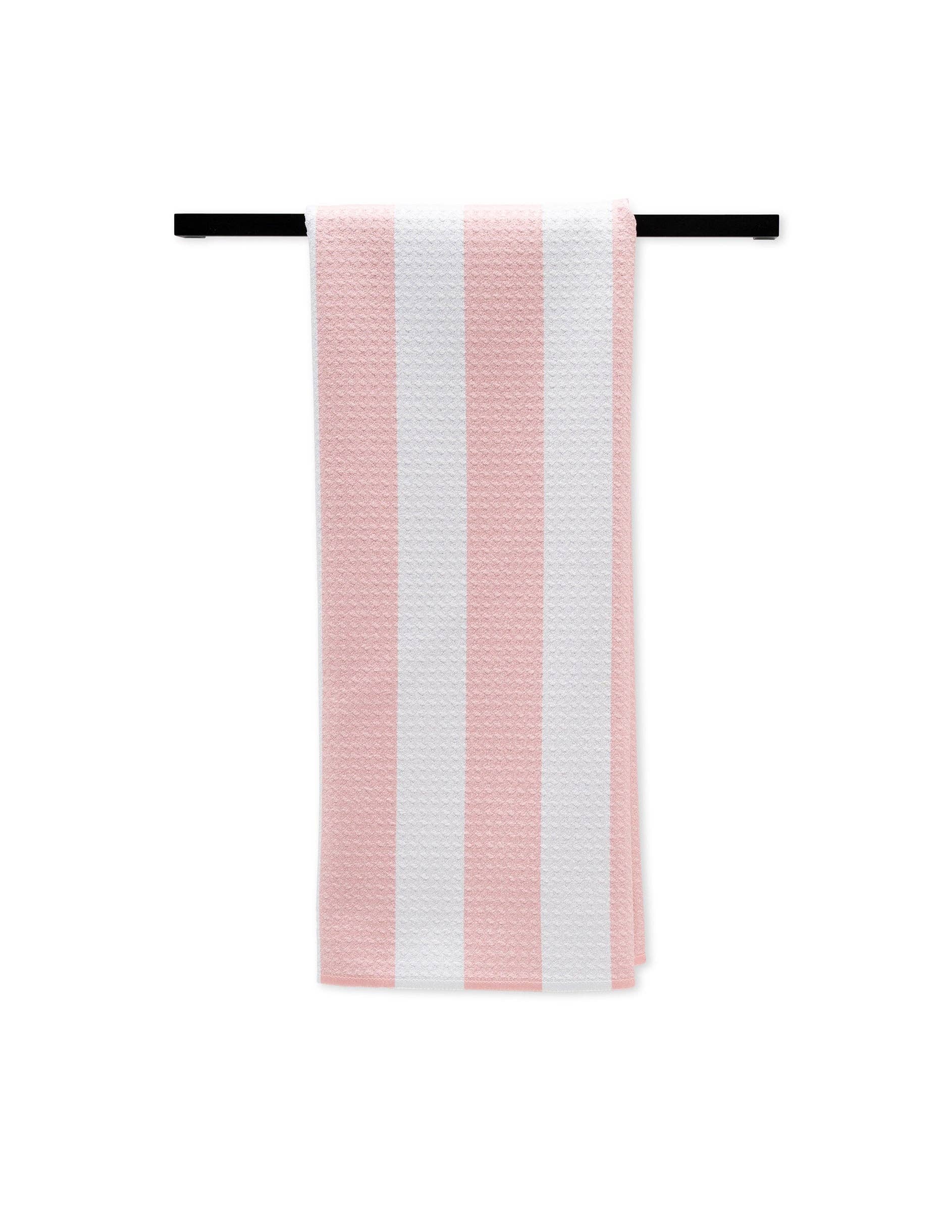 Striped pink and white towel on a black rod against a white background