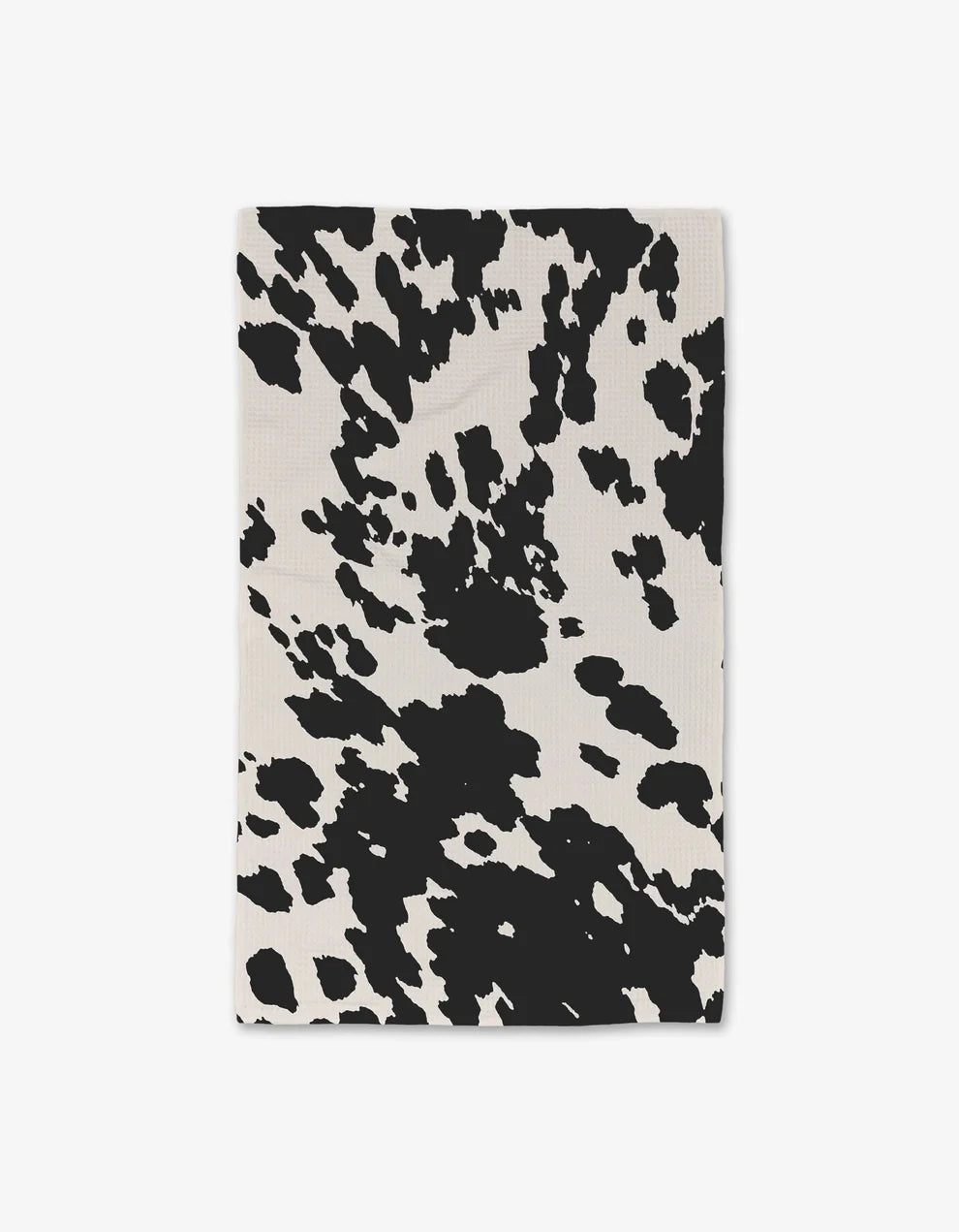 Black and white abstract patterned rug on a plain background