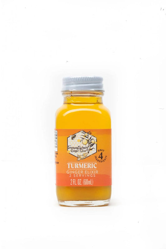 Bottle of turmeric ginger elixir on a white background