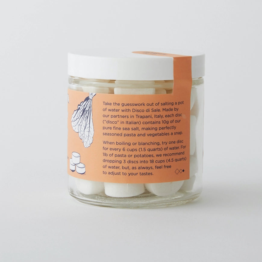 Jar of pasta discs with an orange label on a white background