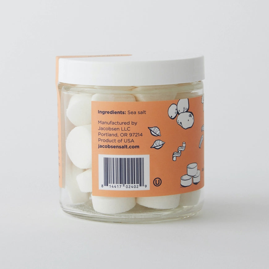 Jar of sea salt with an orange label on a white background