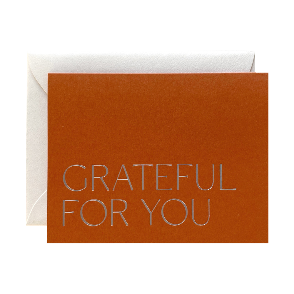 Brown card with 'GRATEFUL FOR YOU' text and white envelope on a white background