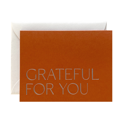Brown card with 'GRATEFUL FOR YOU' text and white envelope on a white background