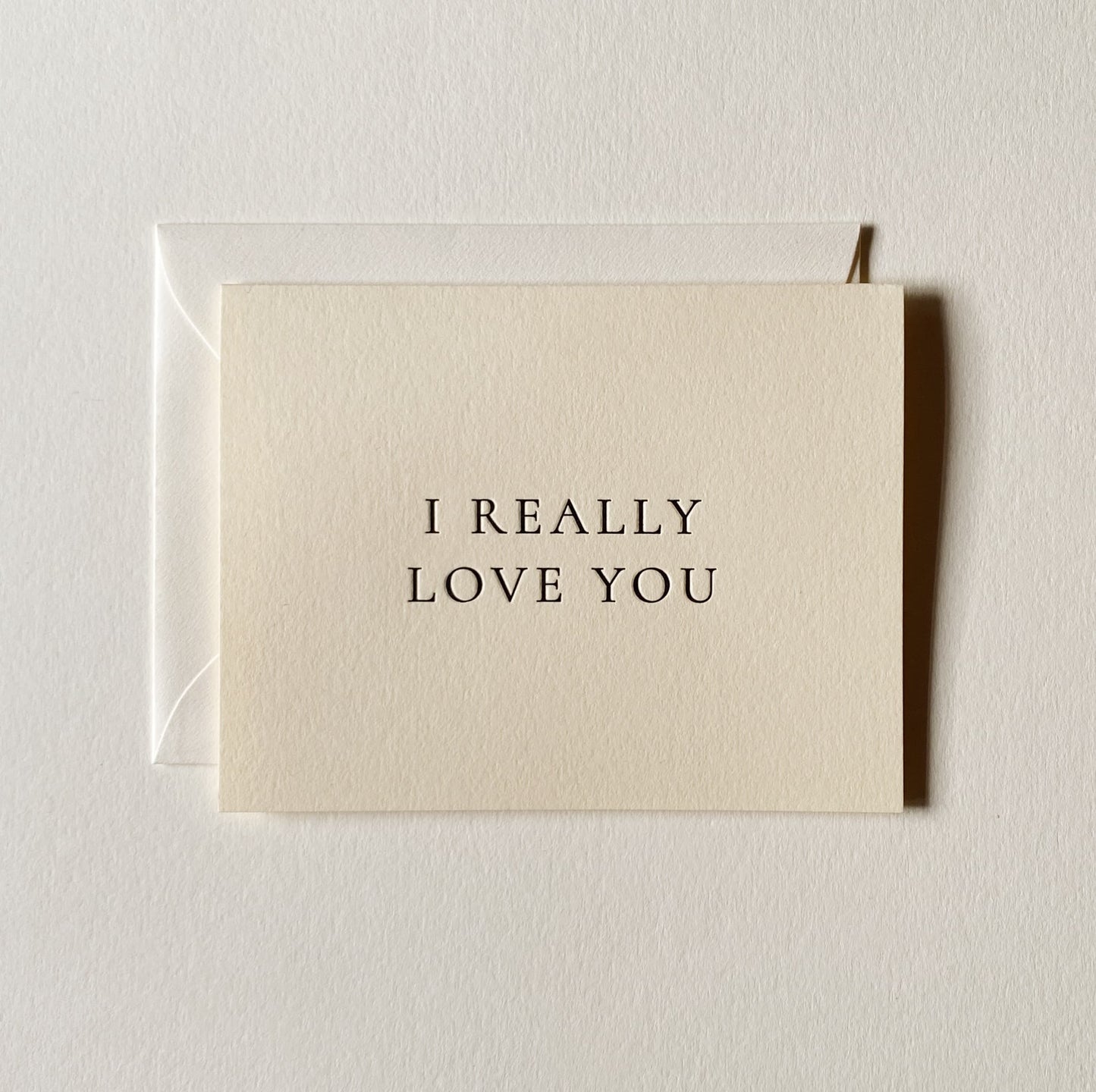 Beige card with 'I REALLY LOVE YOU' text on a light gray background