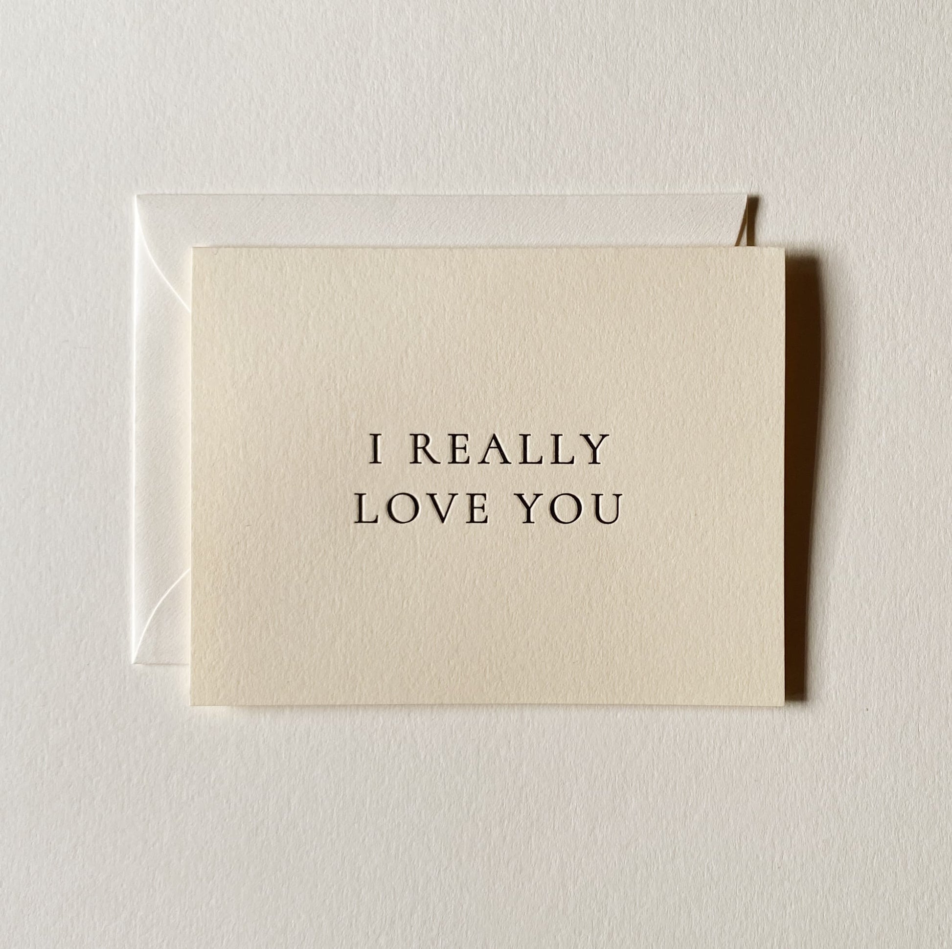 Beige card with 'I REALLY LOVE YOU' text on a light gray background