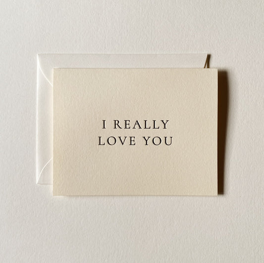 Beige card with 'I REALLY LOVE YOU' text on a light gray background
