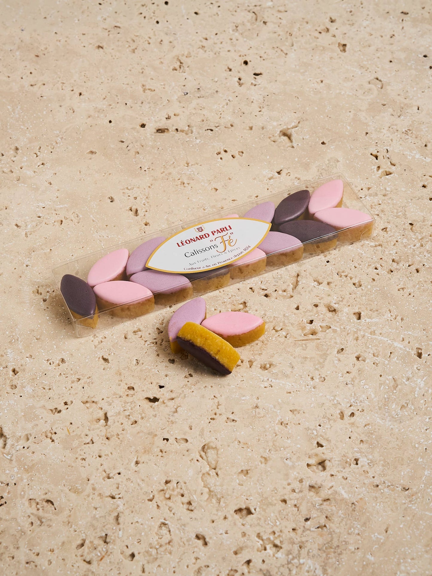 Decorative cookie with pink and brown leaves on a beige surface