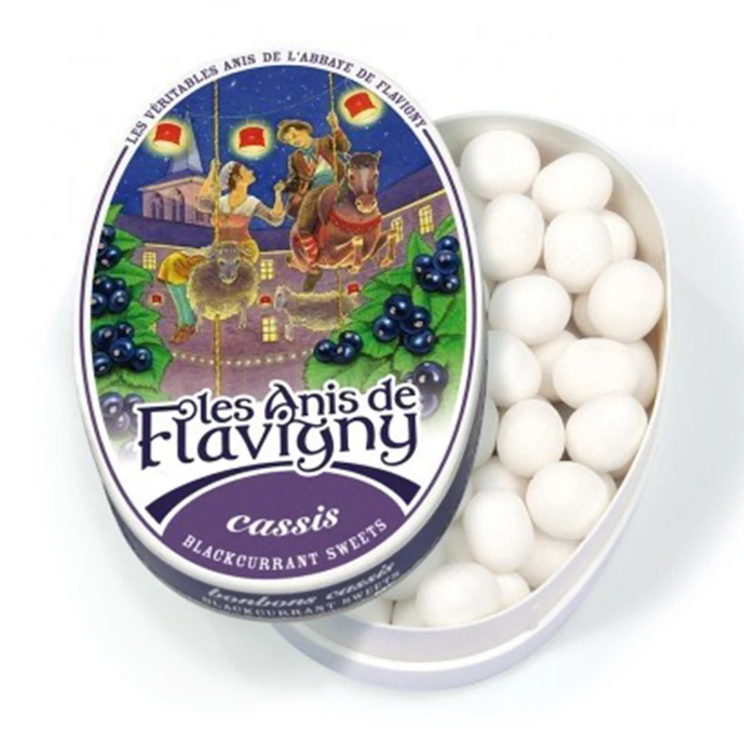 Tin of Foles Anis de Flavigny blackcurrant sweets with decorative label on a white background