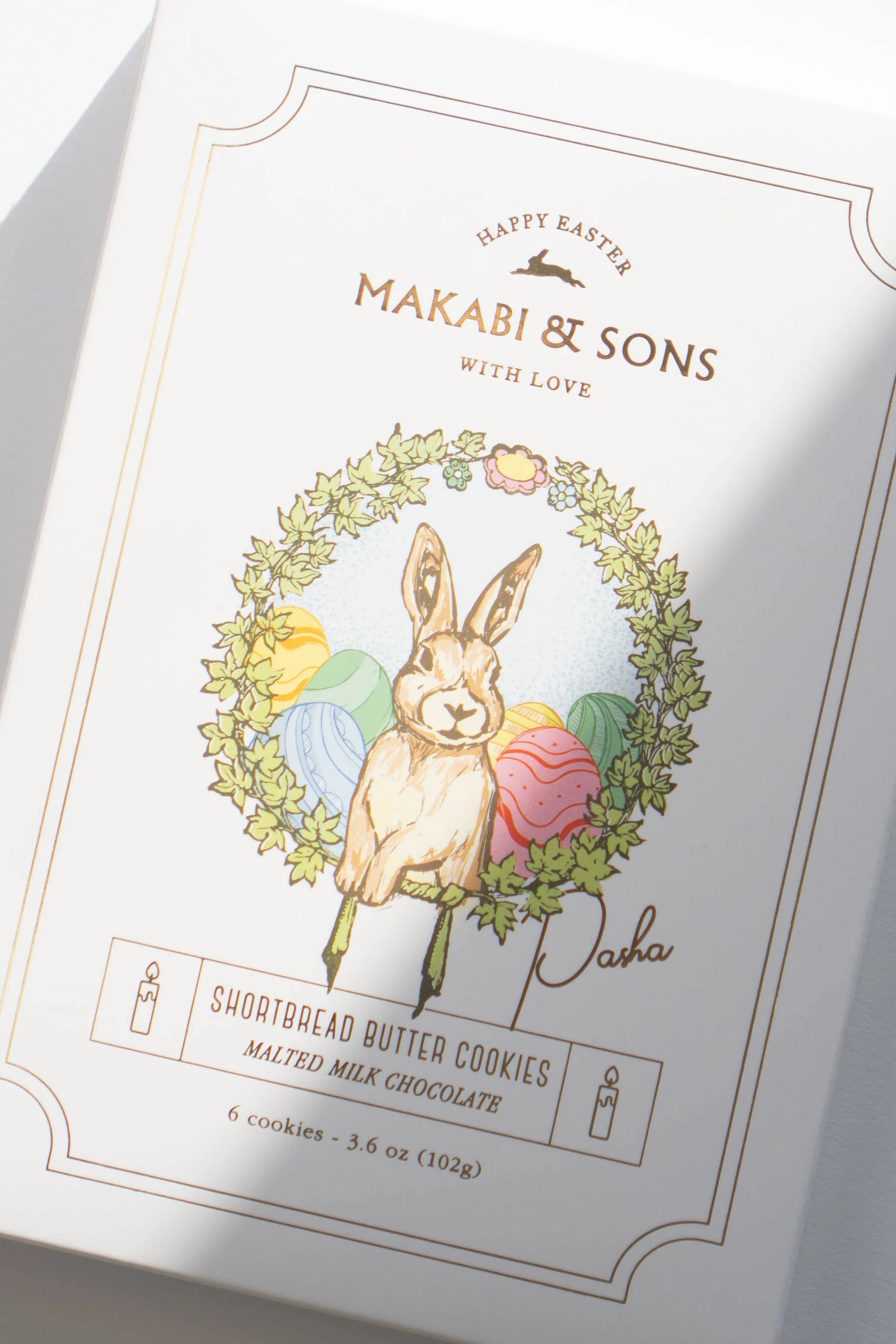 Packaging of Makabi & Sons Easter cookies with a rabbit illustration and floral wreath.