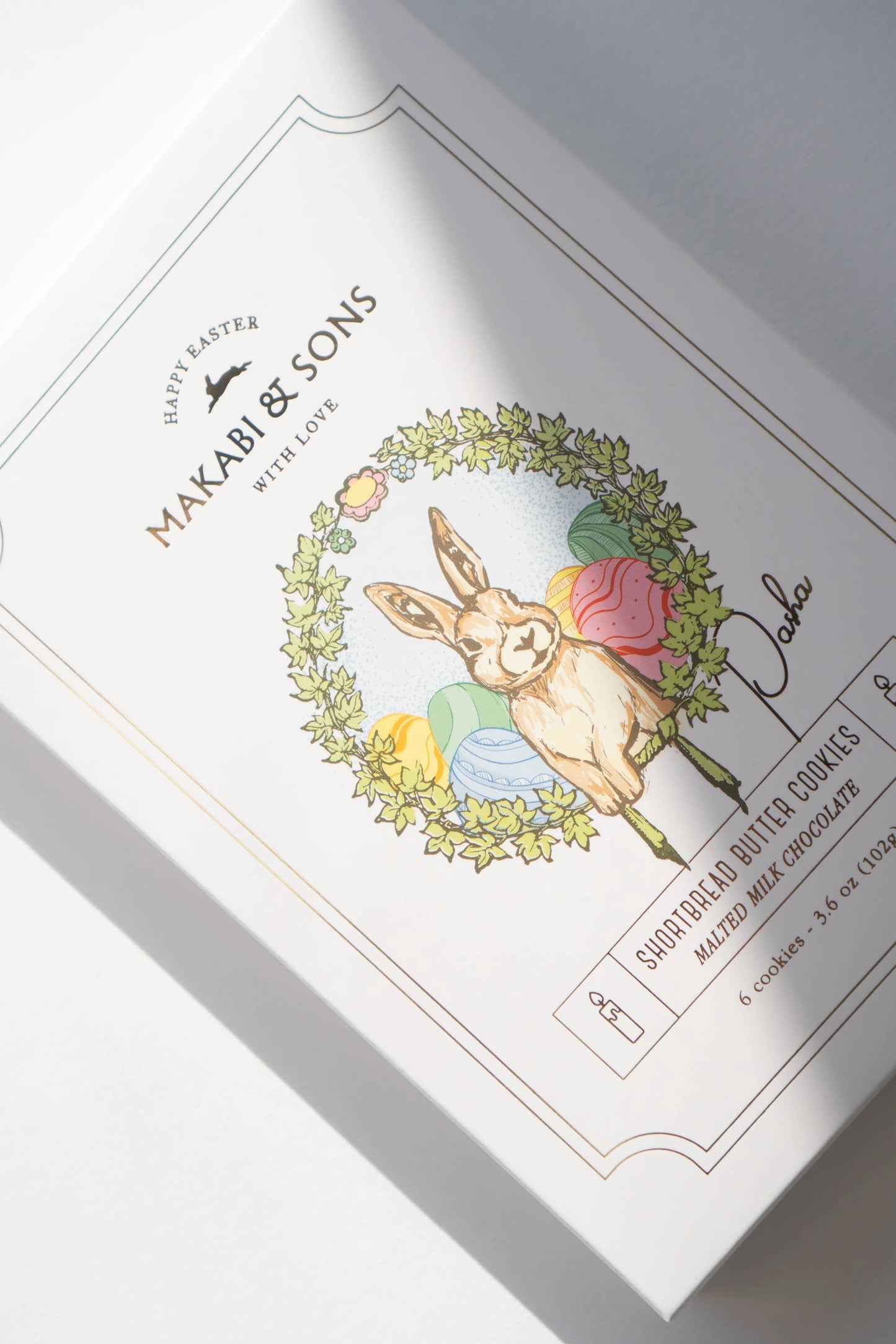 Makabi & Sons Easter cookie packaging with a bunny and wreath design.