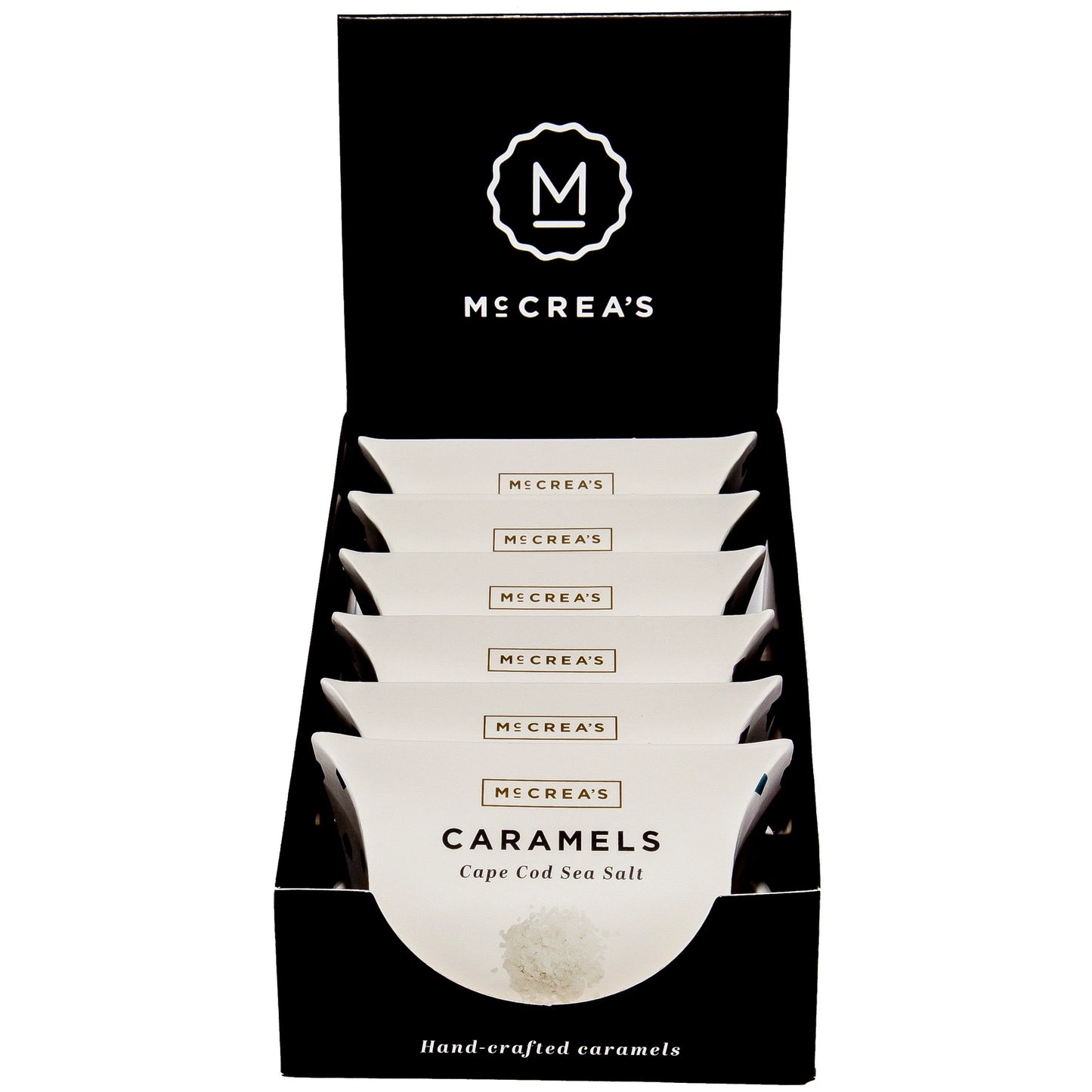 Display of McCrea's Caramels packaging with a black background