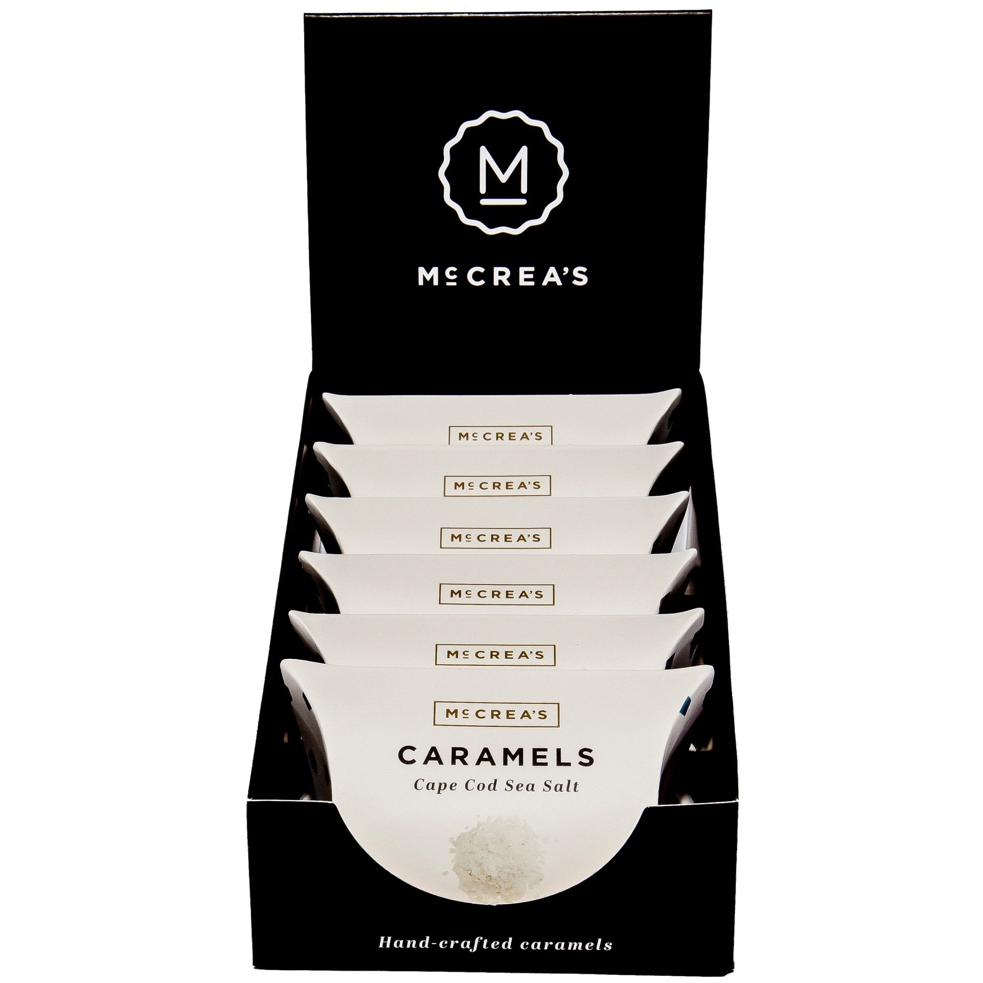 Display of McCrea's Caramels packaging with a black background