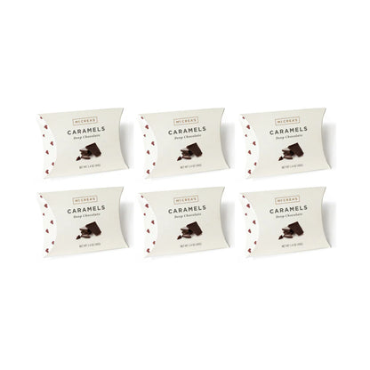 Six packages of Deep Chocolate Caramels on a white background