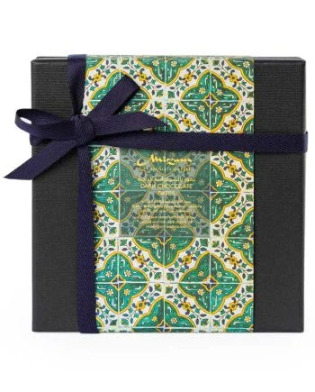 Gift box with decorative pattern and blue ribbon on a white background