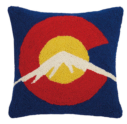 Decorative pillow with a mountain design on a blue background