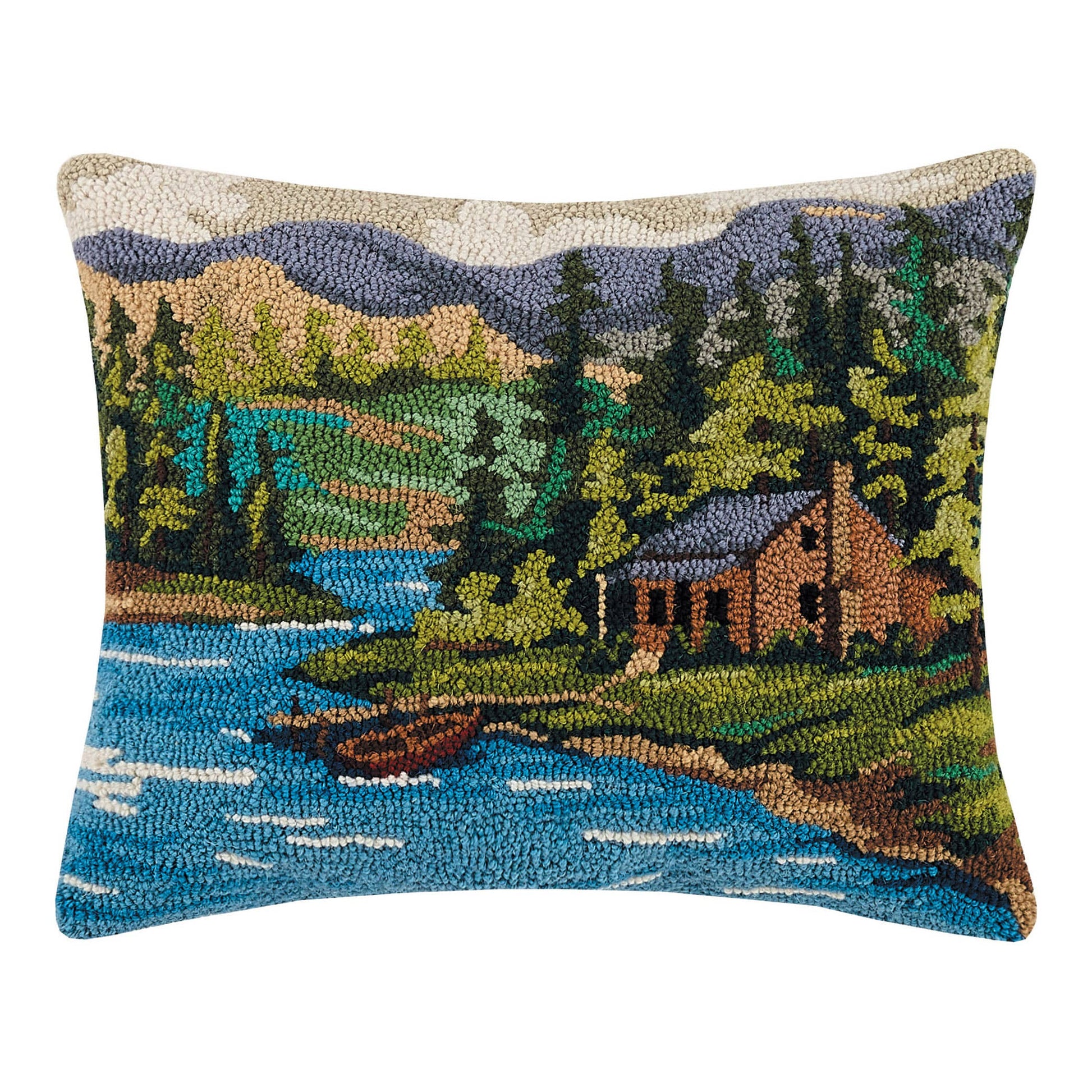 Decorative pillow with a nature scene featuring a cabin by a lake.