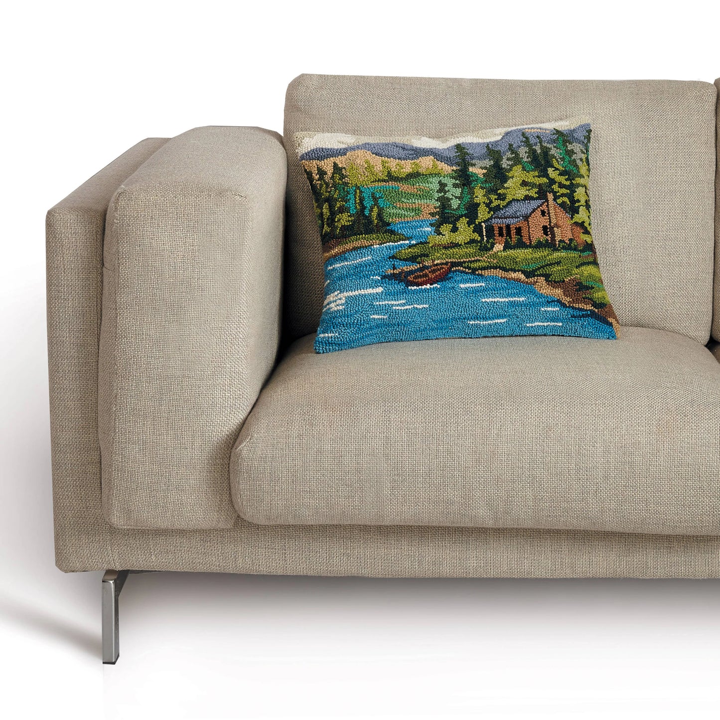 Decorative pillow with a nature scene on a beige sofa