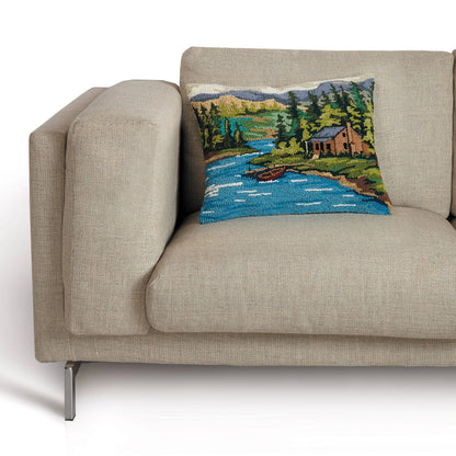 Decorative pillow with a nature scene on a beige sofa