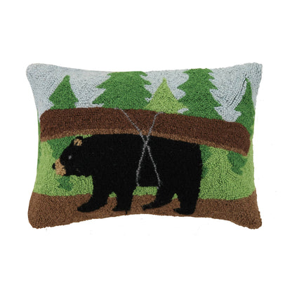 Decorative pillow with bear and forest design on a white background