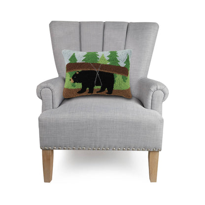 Gray armchair with a decorative pillow featuring a bear design on a white background