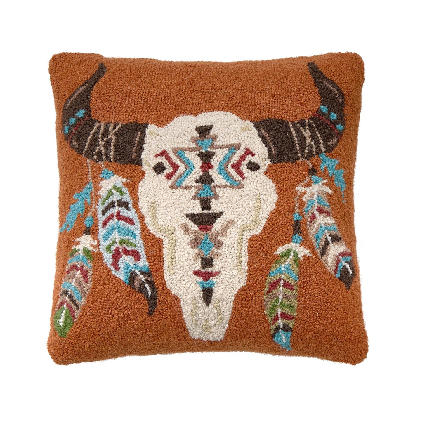 Decorative pillow with bull skull and feathers design on a brown background