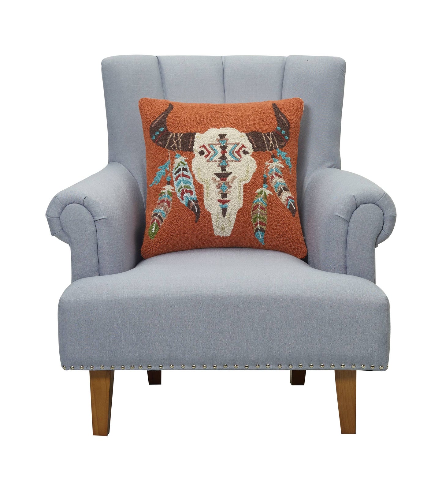 Gray armchair with a decorative pillow featuring a bull skull design on a white background