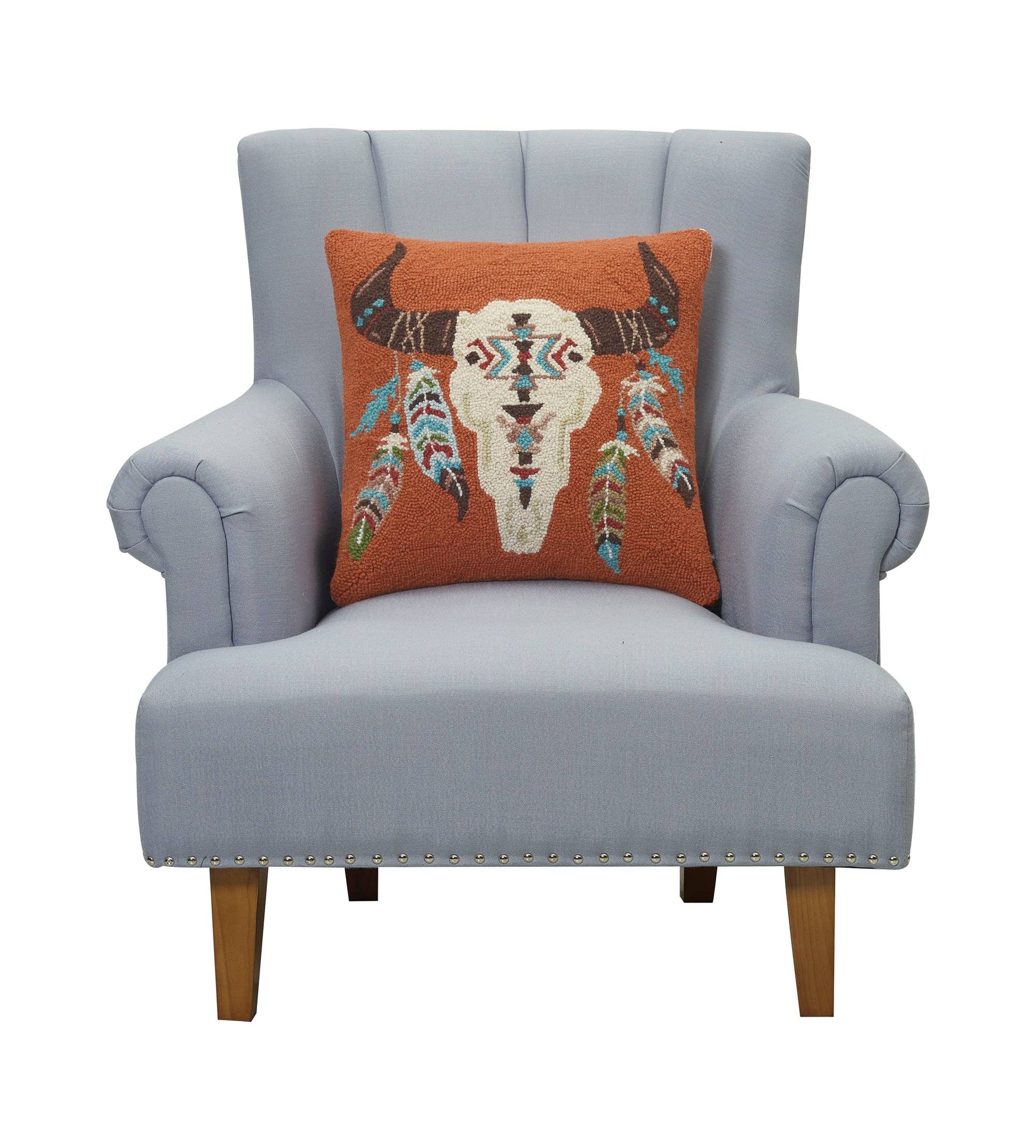 Gray armchair with a decorative pillow featuring a bull skull design on a white background
