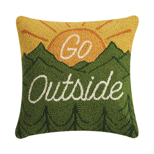 Decorative pillow with 'Go Outside' text and sun design on a white background