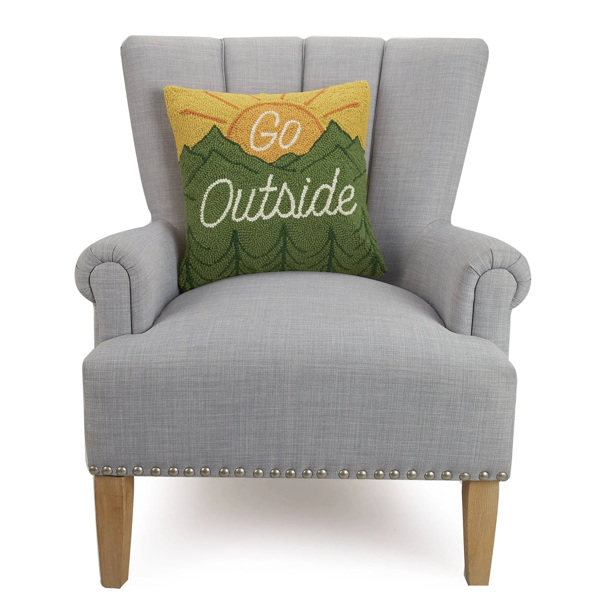 Gray armchair with a decorative pillow that says 'Go Outside' on a white background
