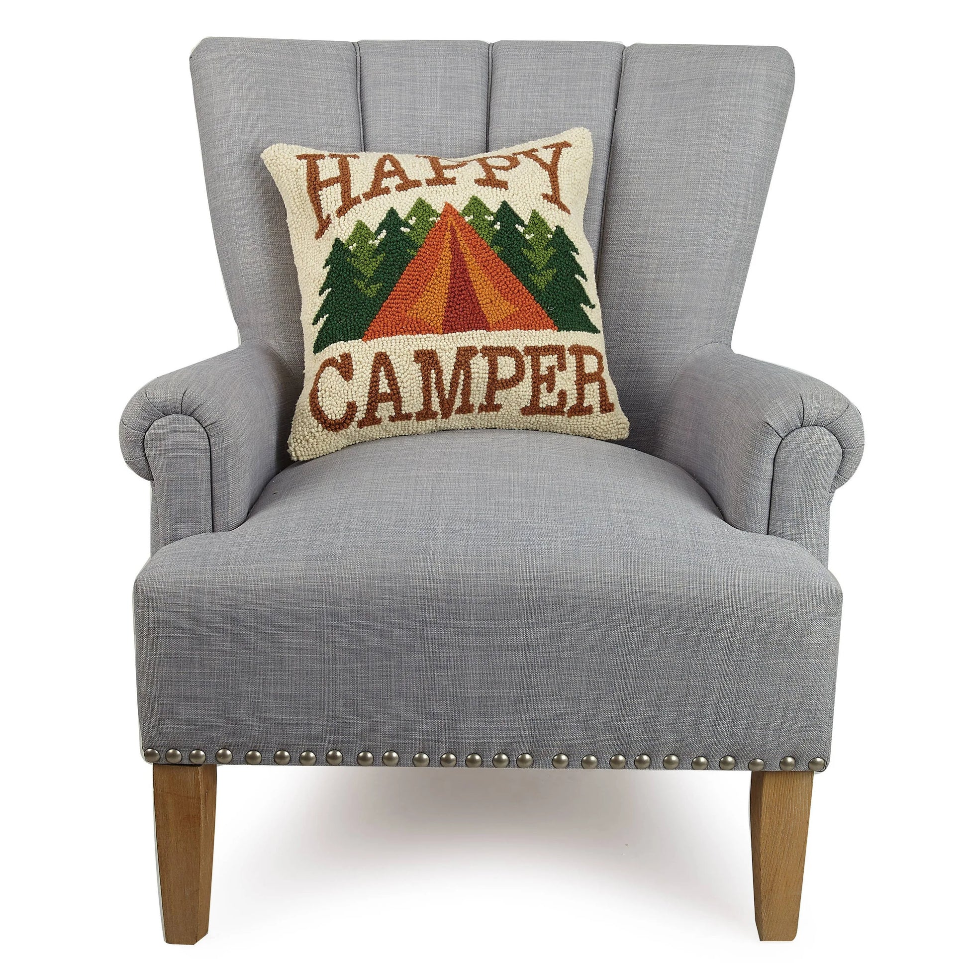 Gray armchair with a 'Happy Camper' pillow featuring a tent and trees design.