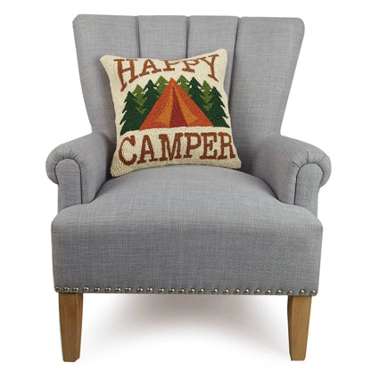 Gray armchair with a 'Happy Camper' pillow featuring a tent and trees design.