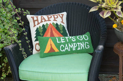 Green cushioned chair with 'Happy Campers' and 'Let's Go Camping' pillows.