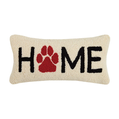 Decorative pillow with 'HOME' and a red paw print on a beige background