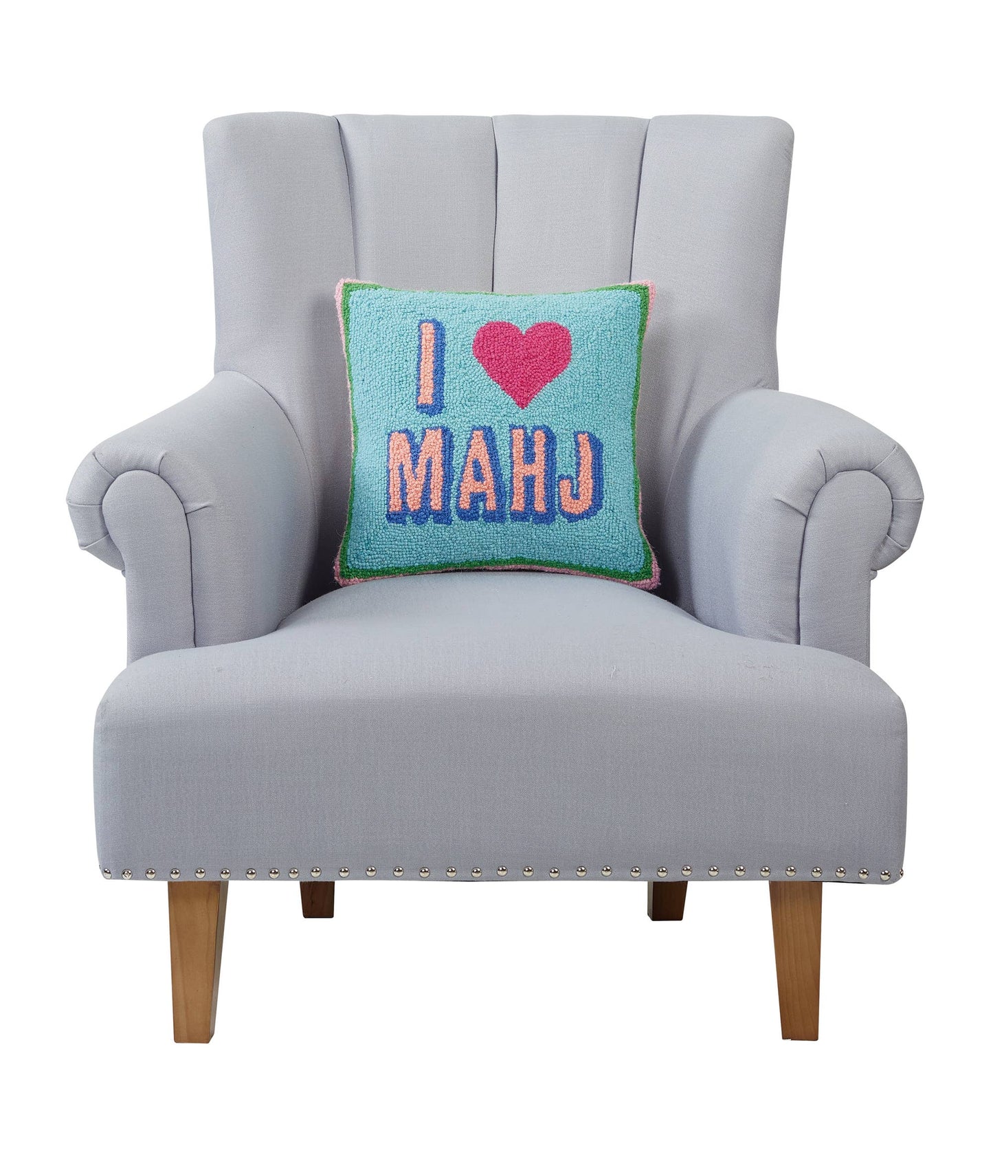 Gray armchair with a colorful pillow that says 'I ❤️ MAHJ' on a white background