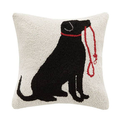 Decorative pillow with a black dog silhouette and red leash on a white background