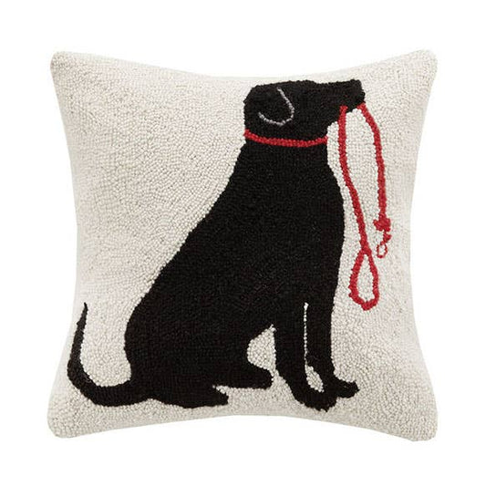 Decorative pillow with a black dog silhouette and red leash on a white background