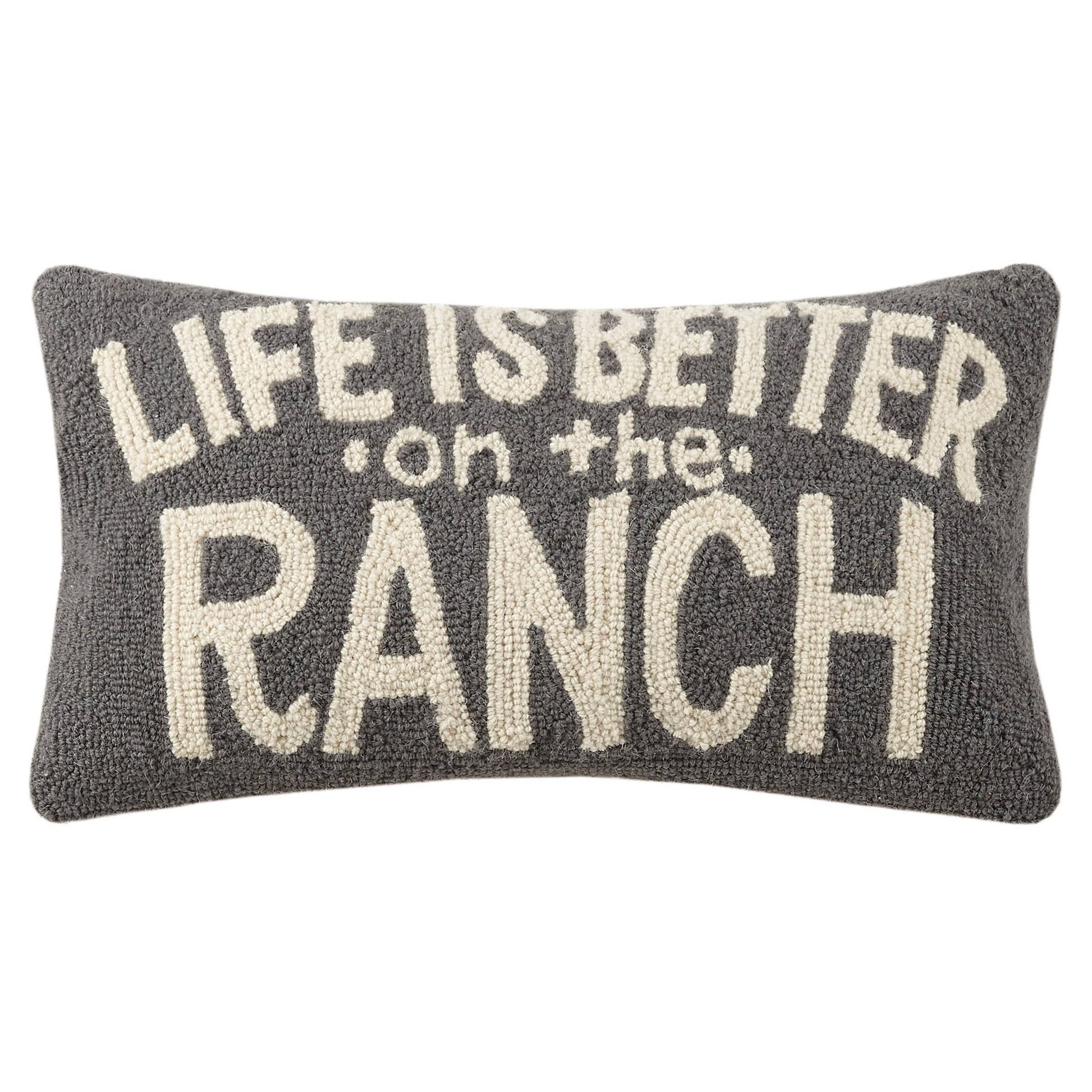 Decorative pillow with 'Life is better on the ranch' text on a white background