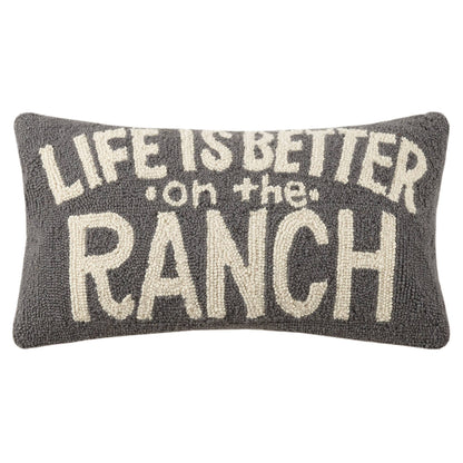 Decorative pillow with 'Life is better on the ranch' text on a white background
