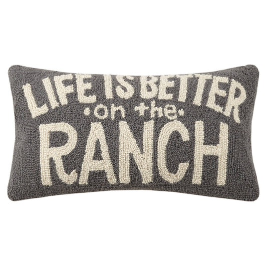 Decorative pillow with 'Life is better on the ranch' text on a white background