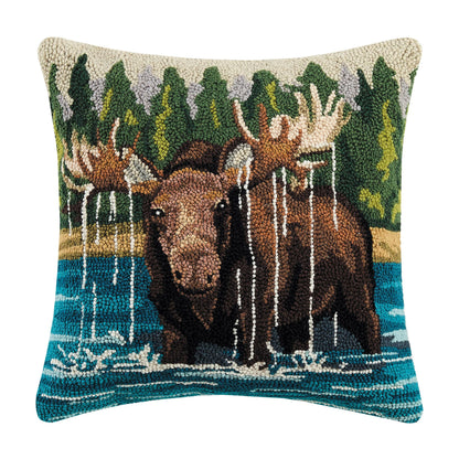 Decorative pillow with moose design in a forest setting