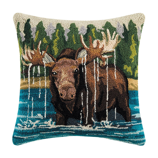 Decorative pillow with moose design in a forest setting