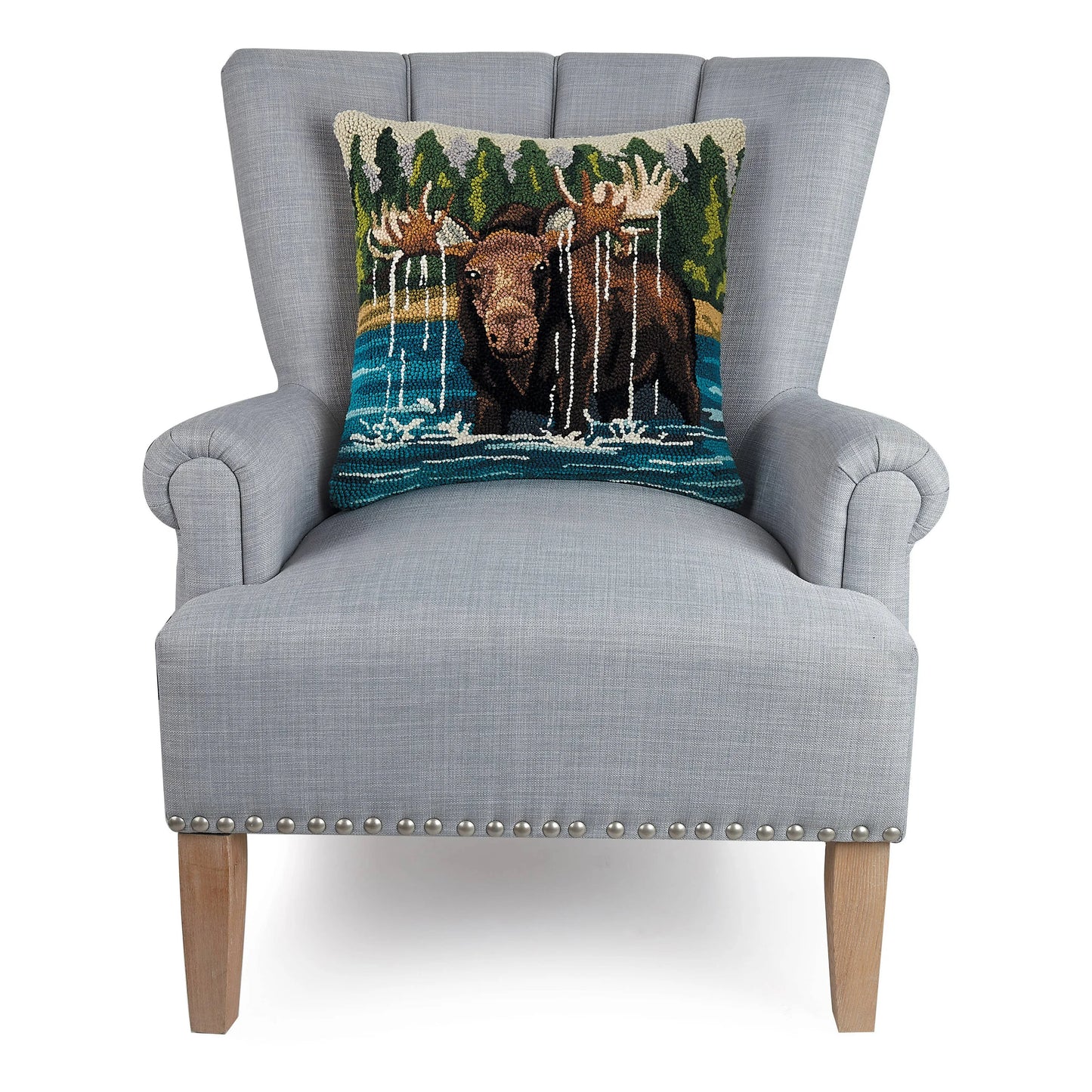 Gray armchair with a decorative pillow featuring moose and nature design on a white background