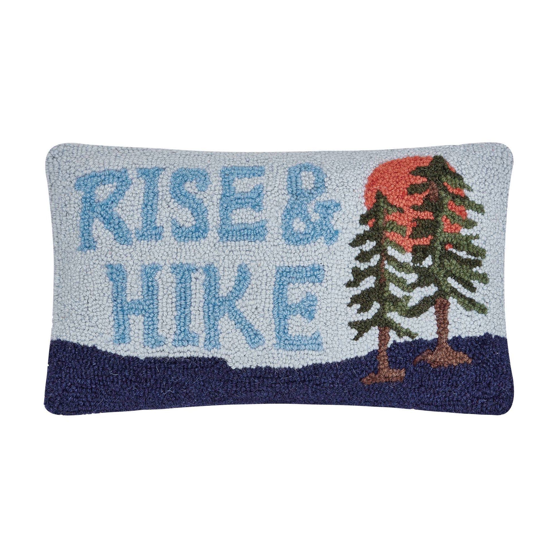 Decorative pillow with 'Rise & Hike' text and mountain design on a white background